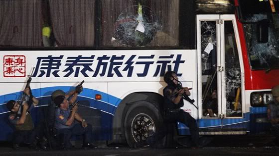 Police commandos assault a bus in a hostage-taking incident at Quirino Grandstand in Manila in the Philippines