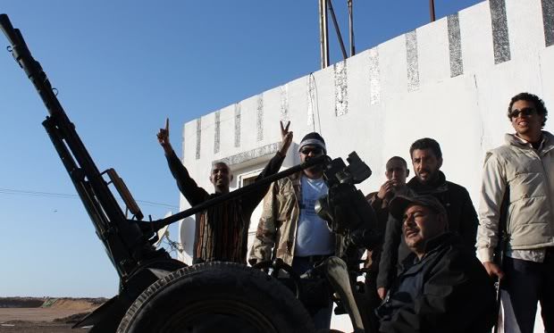 Libyan rebels with a captured anti-aircraft gun
